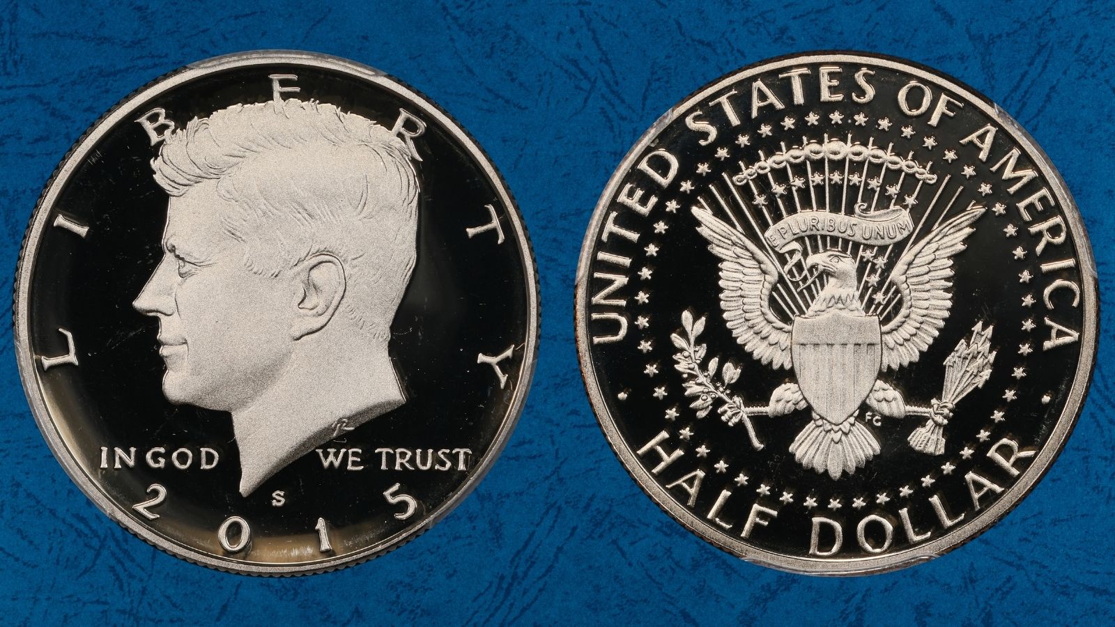 Side-by-side comparison of 2015-D clad half dollar (left) versus 2015-S Silver Proof Deep Cameo (right) showing the dramatic cameo contrast difference