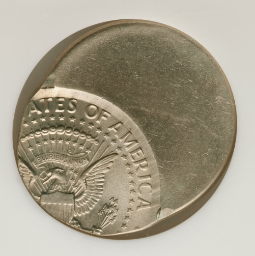 Kennedy half dollar off-center strike error showing 30-50% displacement with visible date and blank crescent