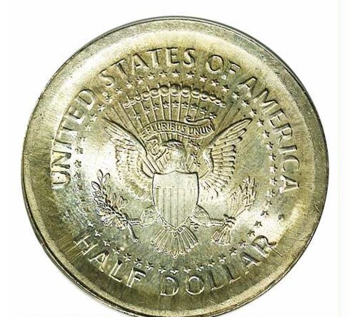 Kennedy half dollar broadstrike error showing enlarged diameter with no collar rim next to normal coin for comparison